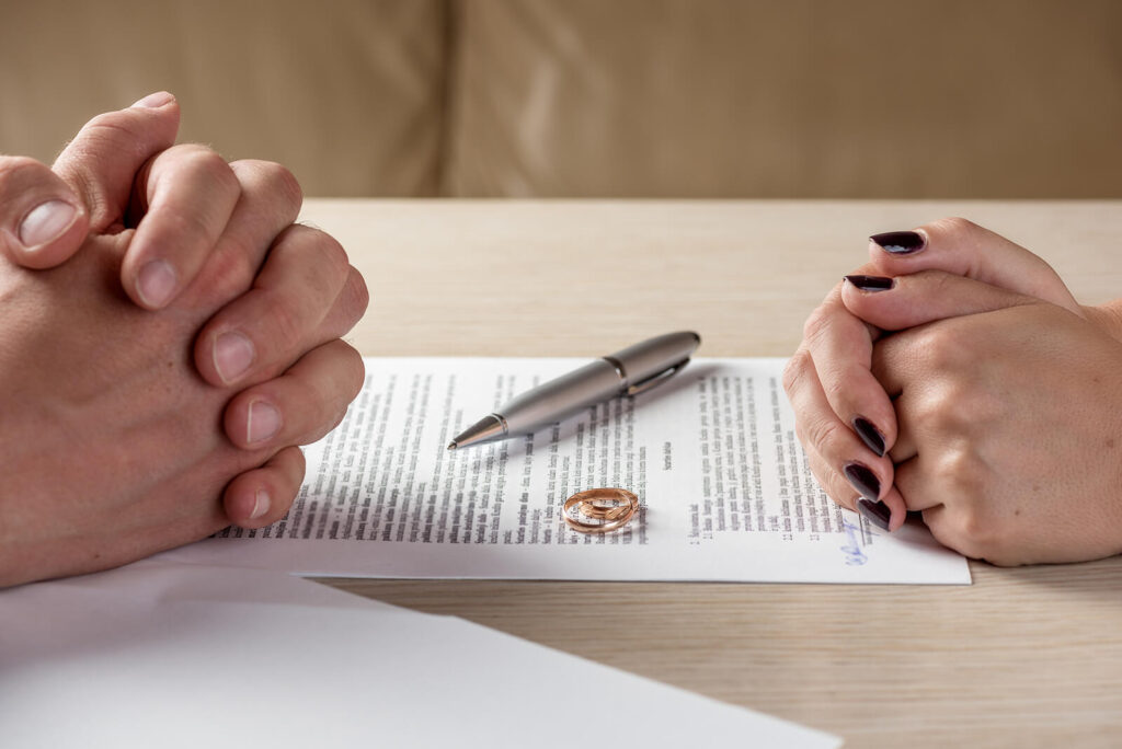 Photo of a man and woman with their hands on divorce papers. Are you considering divorce after infidelity? Relationship counseling in Delray Beach, FL, can help you decide what the right next step may be.