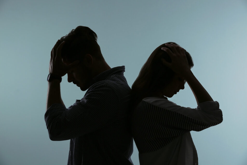 Silhouette of a frustrated couple back to back. If you or your partner keeps bringing up the past in arguments, you're not alone. Relationship counseling in Delray Beach, FL, can guide you toward healthier communication.