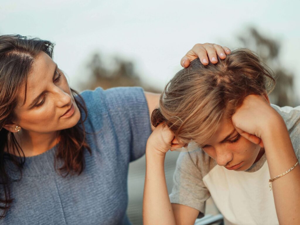 Photo of a woman consoling her young son. Have you suffered from a destructive relationship with your parent? A child and family therapist in Palm Beach, FL, can help you break trauma bonds and set healthy boundaries.