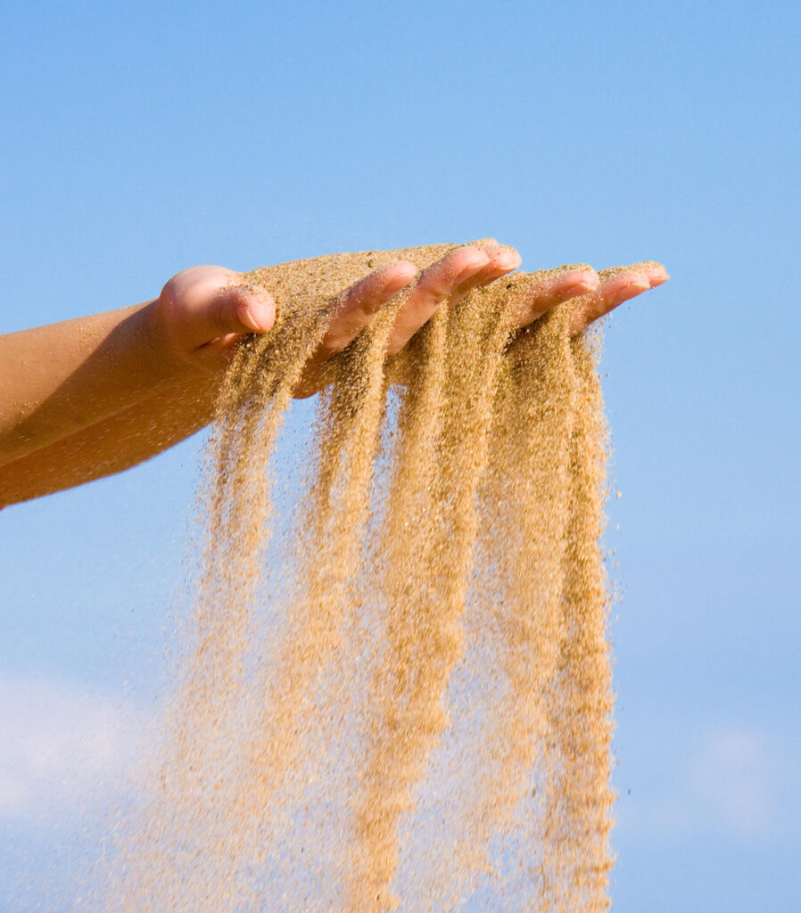 Picture of sand running through a person's hands, representing time running out. If you're experiencing stress and burnout from work, relationship therapy in Delray Beach, FL, can help you achieve work life balance.