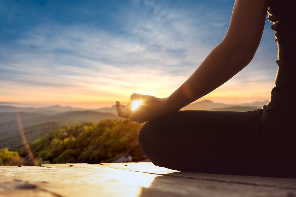 Photo of a woman doing yoga with a nature landscape in the background. If your career is harming your mental health, therapy can help. Work with a relationship therapist in Delray Beach, FL, to find peace. 