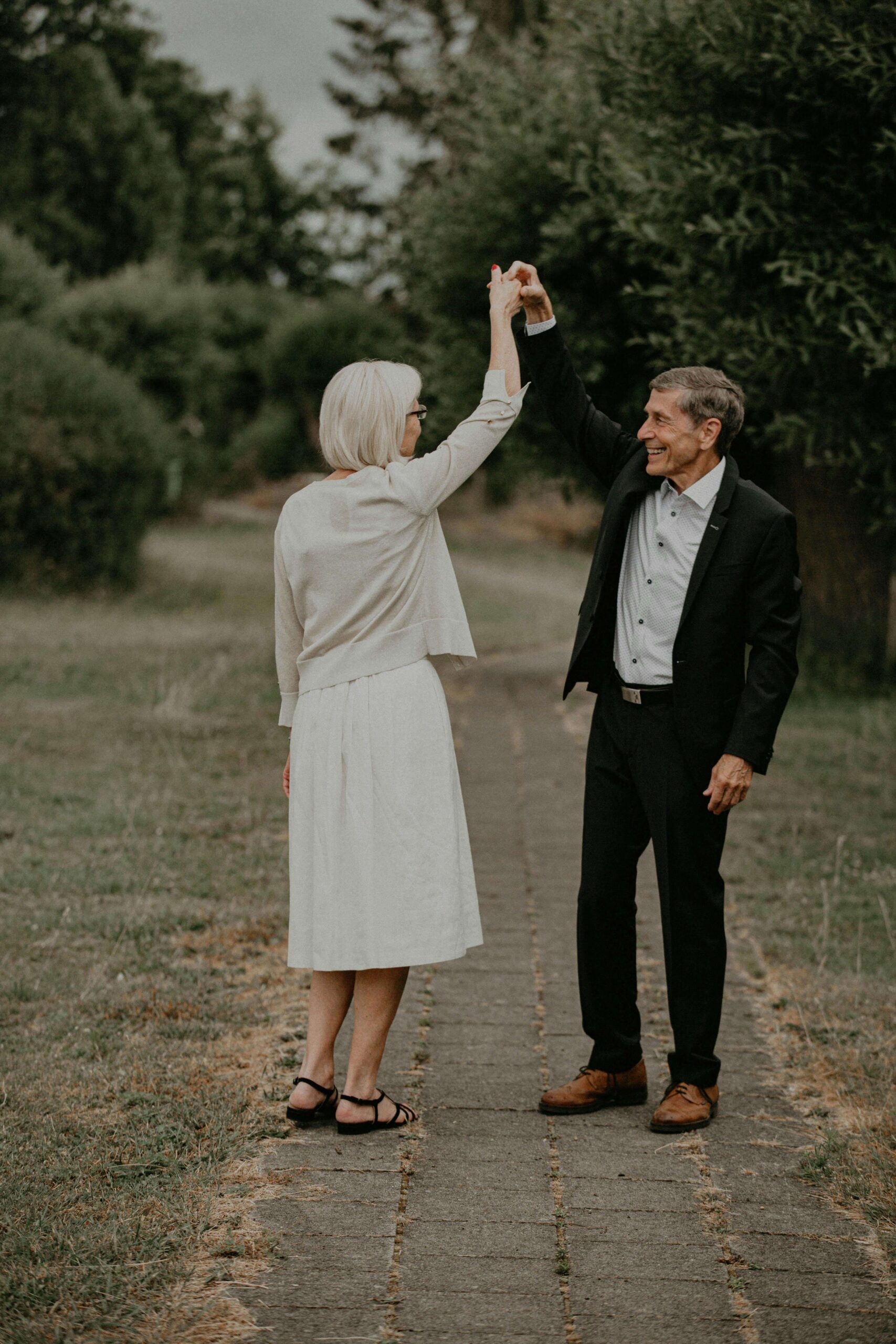 An older couple dances happily together outdoors. A happy marriage often grows from practicing daily habits of care and connection. Relationship counseling in Delray Beach, FL, can guide couples toward stronger bonds and lasting joy.