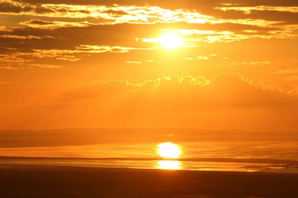 A warm sunset over calm waters, symbolizing peace after overcoming relationship anxiety. Healing emotional patterns creates connection. Relationship therapy in Delray Beach, FL, supports growth and understanding between partners.