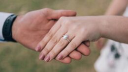 Two hands gently touch, showing an engagement ring. Couples discussing marriage expectations can strengthen emotional understanding. A premarital relationship therapist in Delray Beach, FL, helps partners prepare for lasting commitment.