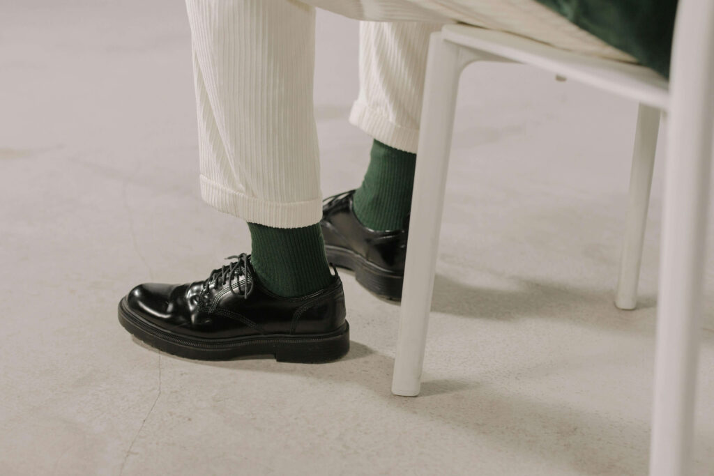 Man’s feet | online anxiety treatment in delray beach, fl | anxiety counselor | anxiety therapy | Highland Beach | Palm Beach County | Boynton Beach A person sits with their feet tense beneath a chair, subtly reflecting anxiety in their posture. Do you struggle to manage physical signs of distress during stressful moments? Anxiety therapy in Delray Beach, FL, can help you build grounding skills that restore calm.