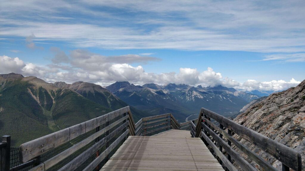 A wooden boardwalk extends toward a panoramic view of layered mountain peaks. Overthinking doesn't have to block your path to achieving meaningful goals and growth. An anxiety therapist in Delray Beach, FL, can help you move forward with confidence.