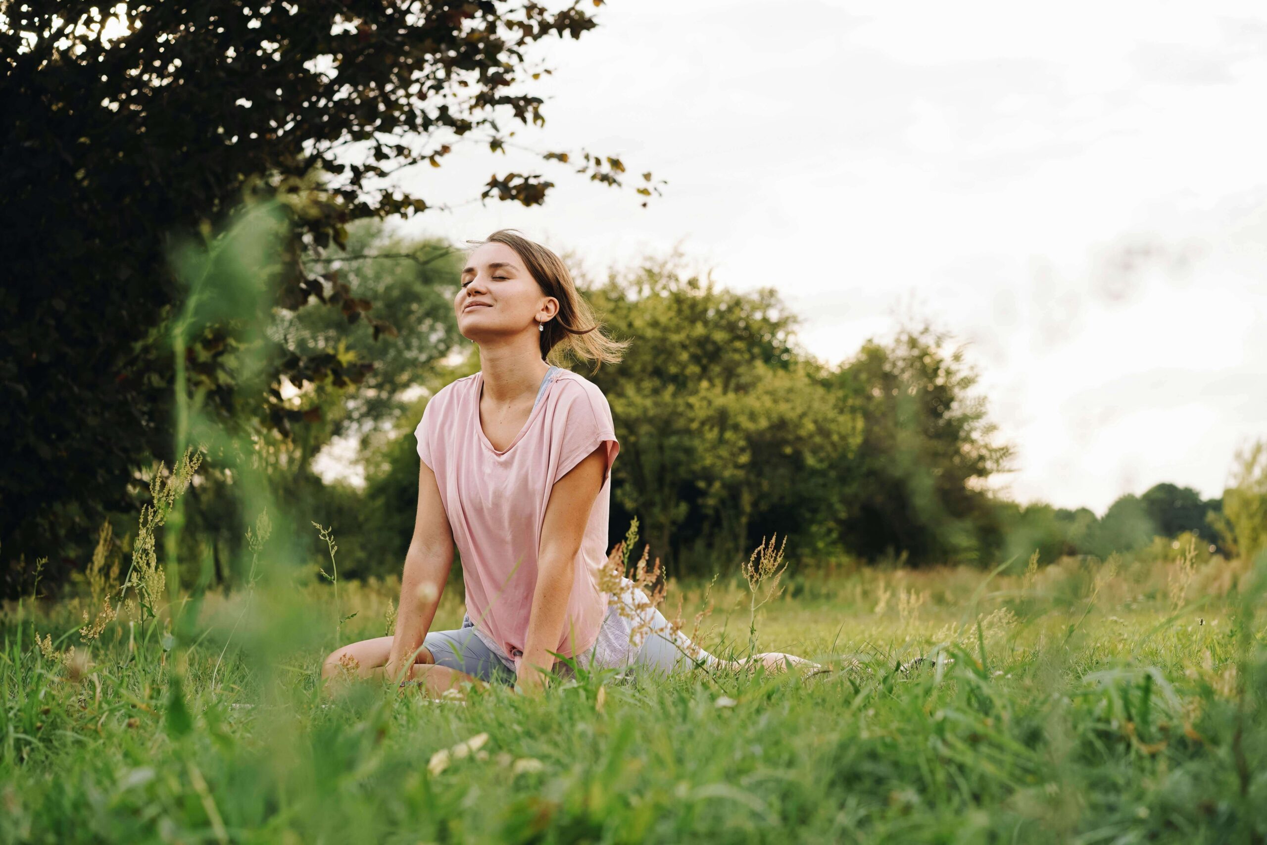 Woman meditating | meditation therapy for anxiety delray beach | anxiety therapist | mindfulness therapy | Delray Beach, Florida | Highland Beach | Palm Beach County | Boynton Beach | The Village by the Sea | Del-Ida Park A young woman sits in a grassy field with her eyes closed peacefully. Meditation is a powerful tool for quieting anxiety and restoring a sense of inner calm. An anxiety therapist in Delray Beach, FL, can help you build a sustainable practice.
