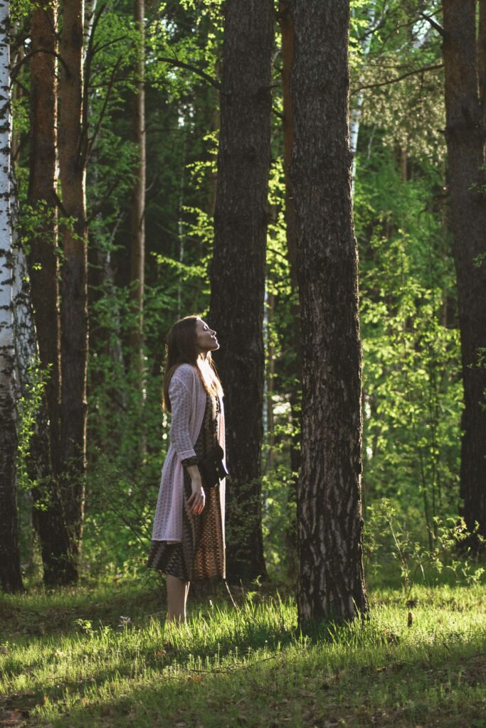 A woman stands among tall trees, eyes closed as she breathes in the dappled sunlight. Have you ever felt anxious for no reason, even in a calm setting like this? Anxiety therapy in Delray Beach, FL can help you understand what's behind those unexpected feelings.