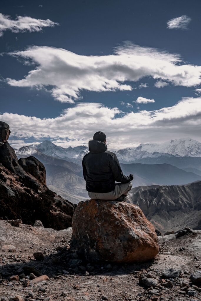 A man sits on a rock, looking out over snow-capped mountains in quiet reflection. What are the signs that severe anxiety has started to take over daily life? Anxiety therapy in Delray Beach, FL can help you find calm and clarity again.